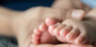 Mother Holding Infant's Feet