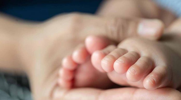 The Vanishing Microbe: Lack of Key Gut Bacteria in 76% of US Babies Linked to Allergy Risk Mother Holding Infant's Feet