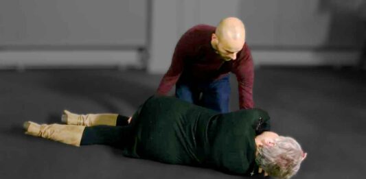 Man Positioning Woman for EMS