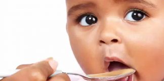 Child Being Fed Peanut Butter