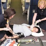 Flight Attendants Tending to Medical Emergency