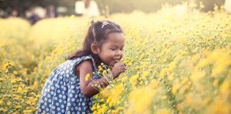 Girl Smelling Flowers