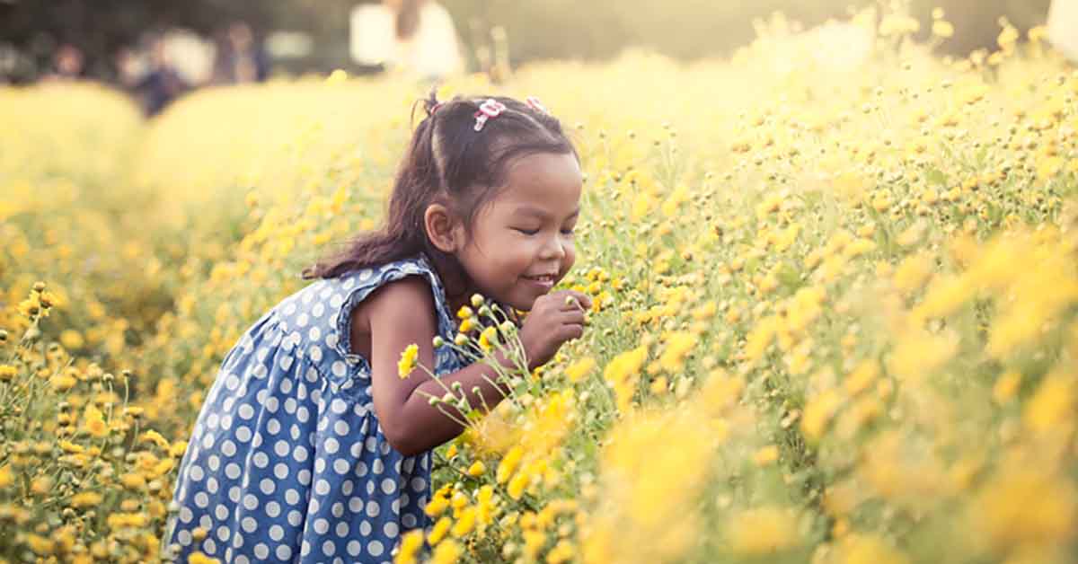 Girl Smelling Flowers