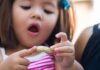 Young Girl Holding Peanut