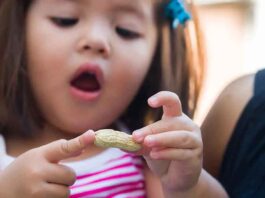 Young Girl Holding Peanut