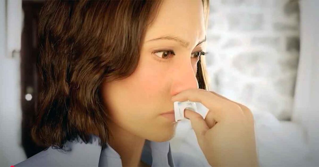 Woman using neffy epinephrine nasal spray