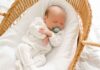 Newborn Sleeping in Bassinet