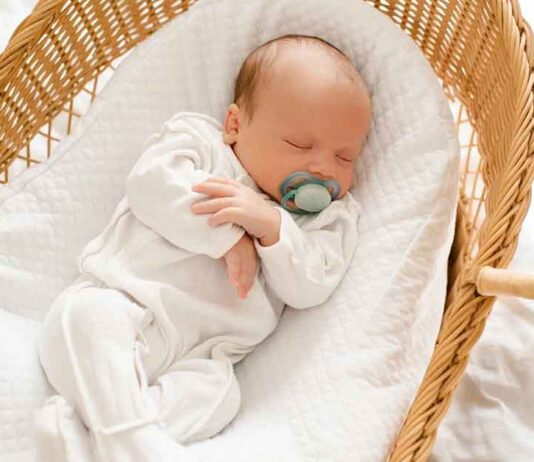 Newborn Sleeping in Bassinet
