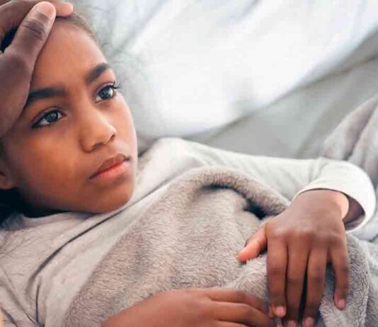 Girl in Bed with Tummy Ache