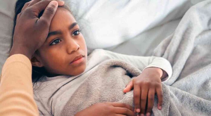 Girl in Bed with Tummy Ache
